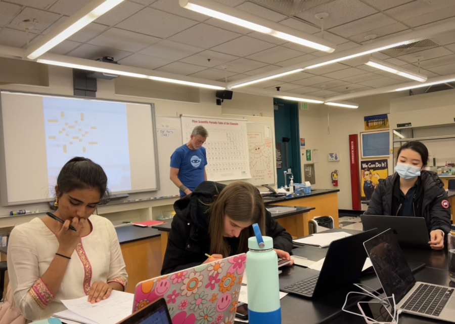 Students work on Chemistry problems as Colin Quinton solves a NYT crossword