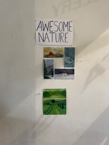 Gallery Leaderships art show welcomes students with sign that reads Awesome Nature and artwork to accompany it.