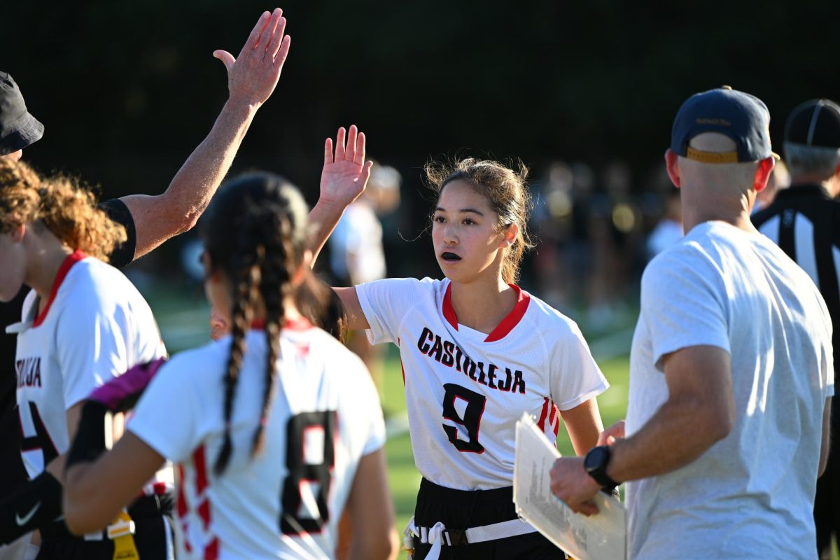 Quarterback Taryn Johnston '26 high-fives her teammates.